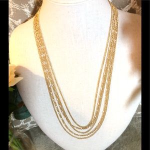 Vintage Monet 5 multi strand gold tone necklace.